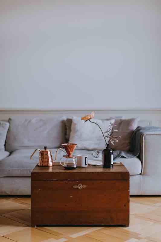 Vintage chest in front of modern sofa